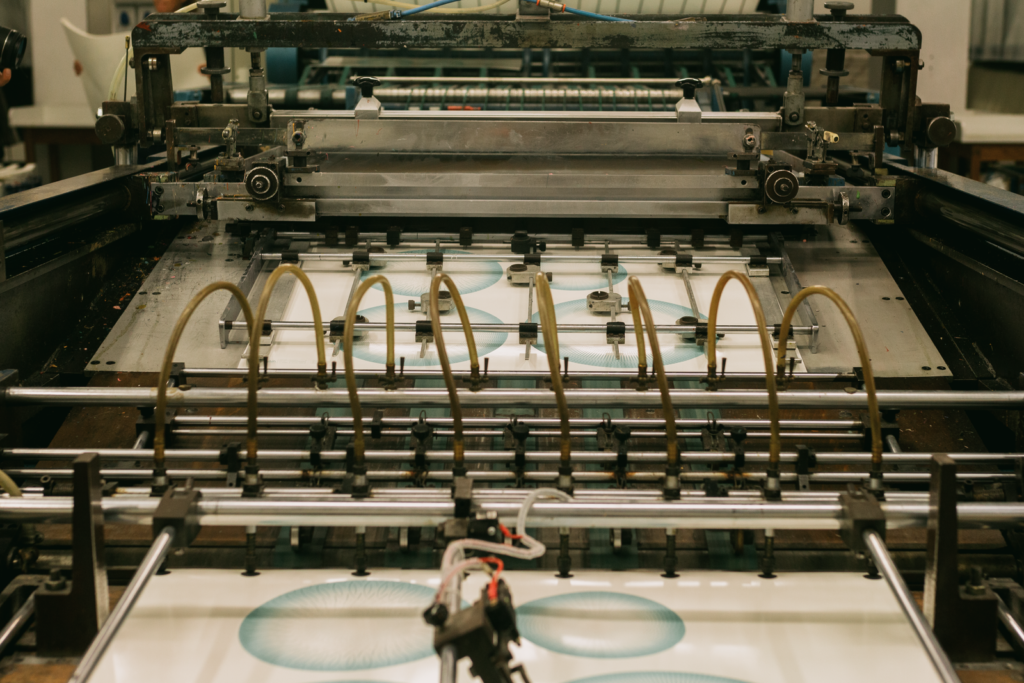 Sheets moving through a large printing press