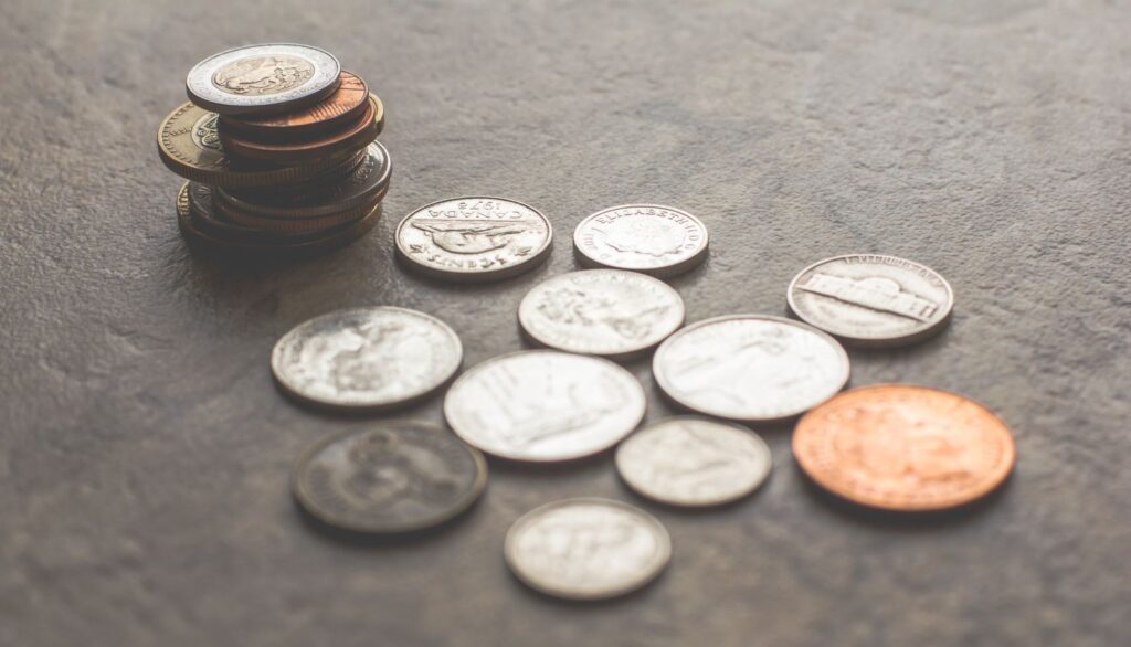 Small stacks of coins on a gray stone surface