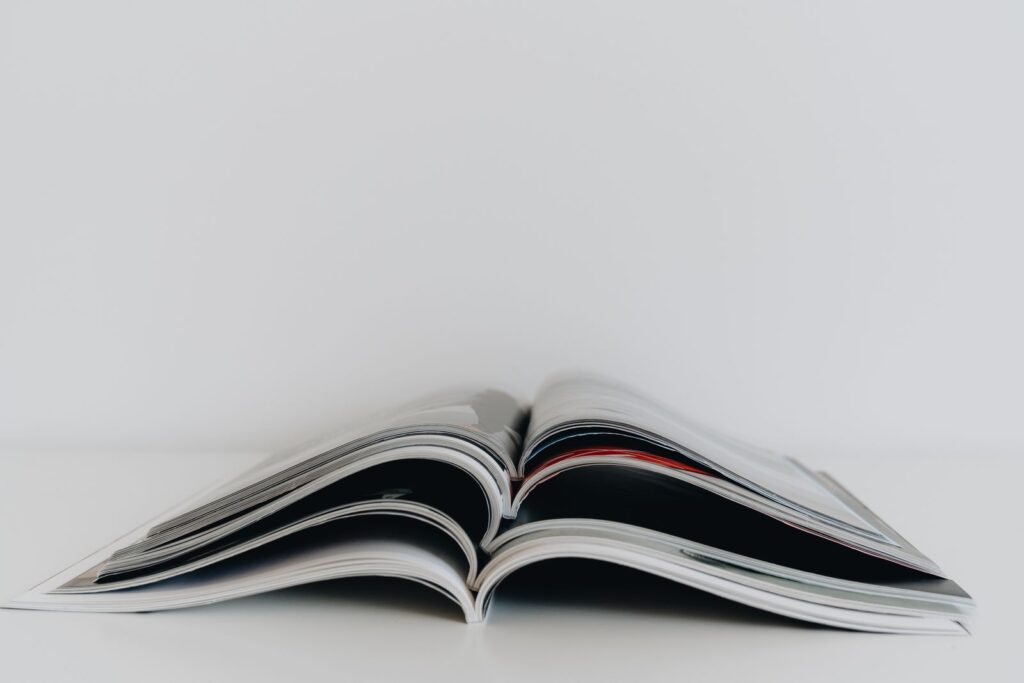 Open magazine lying face down on a white surface